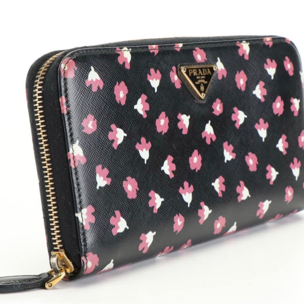 Prada Black Wallet with Floral Motif Zip Wallet.